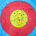 Shooting,Target,And,Bulls,Eye,With,Holes,,Drilled,Background