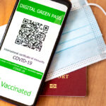 Digital,Green,Pass,Concept:,Smartphone,Over,A,Passport,And,A