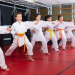 Group,Of,Preteen,Boys,And,Girls,Doing,Karate,Kicks,With