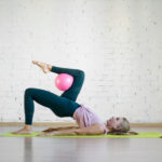Gluteal,Bridge,With,Pink,Small,Fit,Ball.,Caucasian,Girl,Doing